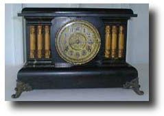 Gilbert Black Wood Clock with columns, circa 1900 — Antique Clocks Price Guide