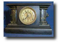 E. Ingraham Black Wood clock with marbleized columns, circa 1900's — Antique Clocks Price Guide
