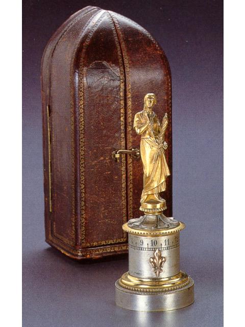 Fine and unusual gilt and silvered bronze, eight-day going keyless small timepiece a cercle tournant, with a small statuette representing Joan of Arc, in original fitted box. Leroy &amp; Cie., 13 et 15, Galerie Montpensier, Paris, circa 1900. — Antique Clocks Price Guide