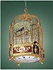 Gilt brass and enamel, two singing bird hanging cage with a center-seconds clock beneath, 12-stream fountain, playing four tunes on demand or changing automatically on the hour. Attributed to Jaquet-Droz, Geneva, circa 1780.