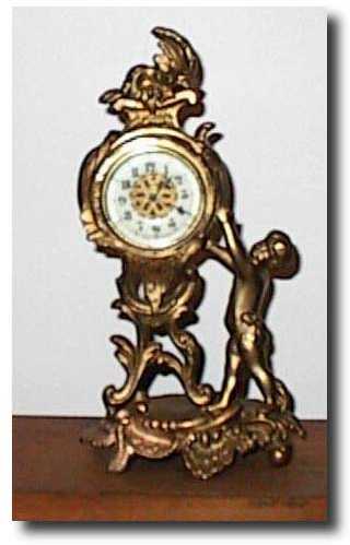 Gold Gilt novelty clock with Cherub — Antique Clocks Price Guide