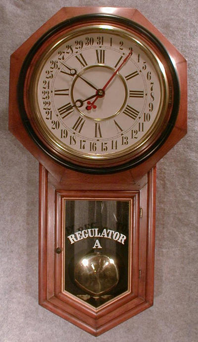 ANSONIA "REGULATOR A" WALNUT VENEER WITH A BLACK BAND BEZEL.. CIRCA 1900-1910. — Antique Clocks Price Guide