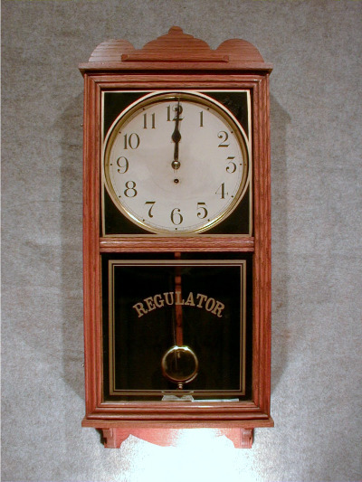 THIS IS AN AMERICAN OAK STORE TYPE WALL CLOCK, CALLED THE "PELICAN" BY THE WATERBURY CLOCK CO. CIRCA 1910-1920. — Antique Clocks Price Guide