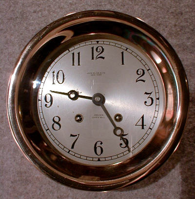 THIS IS A HINGED CASE 6" STRIKING SHIP'S BELL CLOCK IN A RED BRASS CASE. CIRCA 1954. — Antique Clocks Price Guide