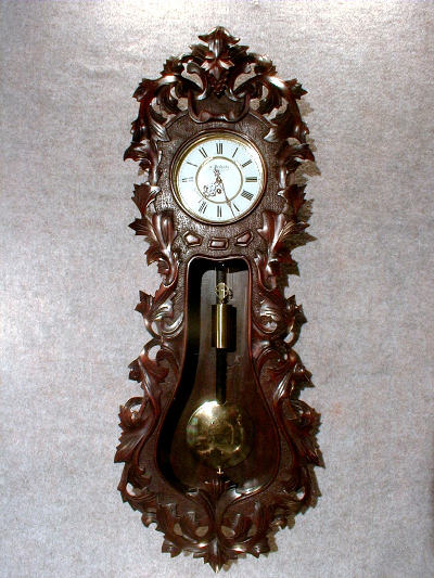 THIS IS AN AUSTRIAN SINGLE WEIGHT WALL REGULATOR IN A HEAVILY CARVED LINDENWOOD CASE. CIRCA 1862-1871. — Antique Clocks Price Guide