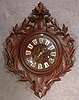 FRENCH CARTEL STYLE WALL CLOCK IN A CARVED OAK CASE, MOTIF IS A CREST WITH OAK LEAVES. CIRCA 1880-1890.