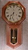 SETH THOMAS "WORLD" WALL CLOCK IN AN OLD OAK CASE. CIRCA 1905-15.