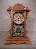 THIS AN ANSONIA OAK SHELF CLOCK THE "AMAZON". THE GLASS HAS A SILVER PATTERN. CIRCA 1895-1900.