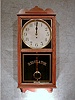 THIS IS AN AMERICAN OAK STORE TYPE WALL CLOCK, CALLED THE "PELICAN" BY THE WATERBURY CLOCK CO. CIRCA 1910-1920.
