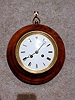 THIS IS A SMALL ROUND FRENCH WALL CLOCK IN AN OAK CASE. CIRCA 1870-1890.