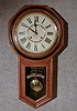 ANSONIA "REGULATOR A" WALL CLOCK. THE CASE IS ASH AND HAS A BLACK BANDED BEZEL. CIRCA 1905-1910.