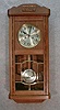 GERMAN BOX CLOCK IN AN OAK VENEERED CASE WITH BEADING DOWN THE DOOR SIDES AND AN APPLIED CARVING AT THE TOP. CIRCA 1910-1920.