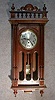 FRENCH WESTMINSTER BOX CLOCK. WALNUT CASE WITH WIDOWS WALK TOP AND CARVED TOP PIECE. CIRCA 1910-20.