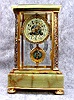 THIS IS A FRENCH CRYSTAL REGULATOR IN A GOLD PLATED CASE WITH CHAMPLEVE ENAMEL INLAYS. CIRCA 1900.
