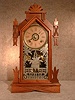 WALNUT CASED SHELF CLOCK "AMERICA", BY THE ANSONIA CLOCK CO. CIRCA 1885-1895.