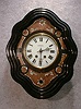 THIS IS A DWARF FRENCH PICTURE FRAME WALL CLOCK IN A SQUIGGLE FRAME. CIRCA 1900.
