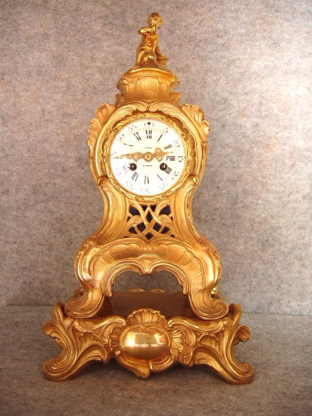 French Cast Brass In A Gilt Finish Serpentine Style Mantel Clock On An Attached Base.  Circa 1860-1880. — Antique Clocks Price Guide