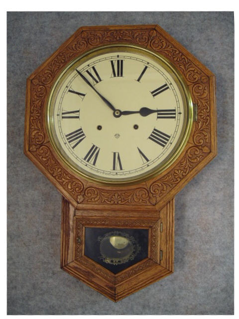 This Is An Ansonia Short Drop School Clock In An Oak Embossed Case, "Drop Octagon Extra".  Circa 1900-1910. — Antique Clocks Price Guide