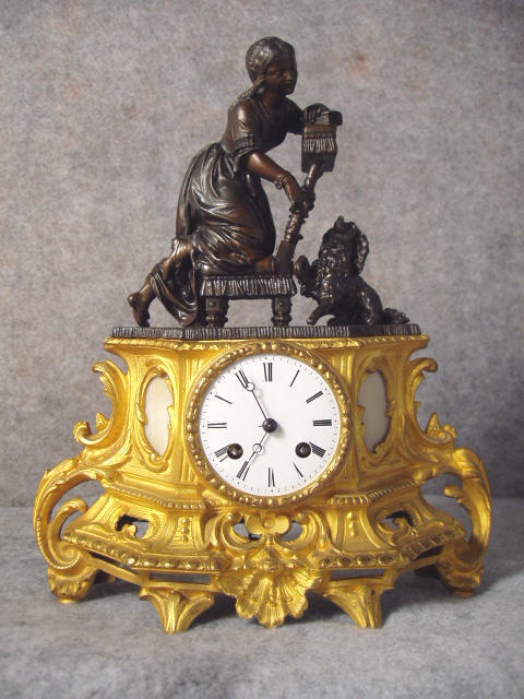 French Spelter Mantel Clock In Bronze And Gilt Finishes With Alabaster Inserts On Each Side Of The Dial. — Antique Clocks Price Guide