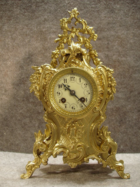 A French Mantel Clock In A Solid Brass Serpentine Style Case With A Garland Hanging Down From The Top. Circa 1880'S. — Antique Clocks Price Guide