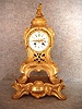 French Cast Brass In A Gilt Finish Serpentine Style Mantel Clock On An Attached Base.  Circa 1860-1880.