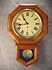 This Is An "Admiral" Short Drop Oak School Timepiece By The Gilbert Clock Co.