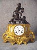 French Spelter Mantel Clock In Bronze And Gilt Finishes With Alabaster Inserts On Each Side Of The Dial.