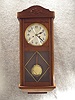 German Box Clock In An Oak Case With An Applied Carving On The Crown And Beading Down The Sides Of The Door. Circa 1910.