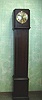 Deco Style German Oak Cased Granddaughter Clock With Decorative Moulding And Beading On The Case. Circa 1910-20.