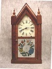 Sharp Gothic (Steeple) Shelf Clock By Chauncey Goodrich In A Rosewood And Mahogany Veneered Case With The Original Finials, Circa 1855-60.