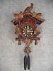 30 Hour Weight Driven German Cuckoo Clock In A Carved Grape Leaf And Grape Motif With A Diving Bird On The Center Of The Crown. Circa 1900-1910.