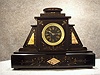 French Mantel Clock In A Black Slate Case With Marble Inlays And Accents. Circa 1880'S.