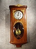 French Box Clock In A Mahogany Case With Brass Mountings And Has An Oval Beveled Glass In The Lower Part Of The Door.