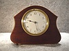 French Boudoir Clock In A Mahogany Case With Satin Wood And Ebony Banding And Sits On Brass Feet. Circa 1920.