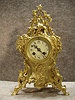 A French Mantel Clock In A Solid Brass Serpentine Style Case With A Garland Hanging Down From The Top. Circa 1880'S.