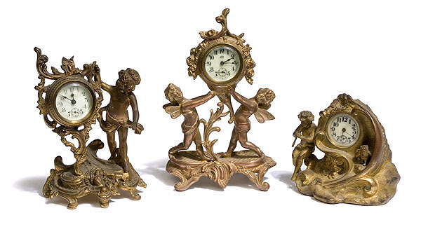Three Figural Cherubic Novelty Clocks, — Antique Clocks Price Guide