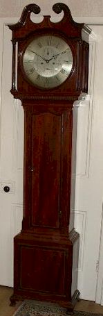 A mahogany longcase clock from the Derby school of influence incorporating the round dial of the area. The case is of particularly good quality with great attention to detail; for example, the carved paterae and the ebony and boxwood stringing. — Antique Clocks Price Guide