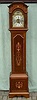 A small Edwardian longcase clock with a mahogany case inlaid with fruitwoods and boxwood.