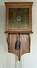 A late eighteenth century single-handed hooded wall timepiece with alarm.