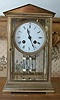 A French Clock circa 1912 in a gilt-brass four-glass case of architectural form.