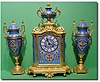 French gilt bronze and cloisonne enamelled three piece clock garniture, circa 1870.