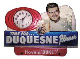 Advertising clock for "Duquesne Pilsner" beer. The metal case is 13inches wide and 9 inches high. — Antique Clocks Price Guide