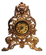 Gilt novelty clock. Very ornamental, gold plated, metal frame, 11 inches high. — Antique Clocks Price Guide