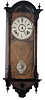 Miniature Vienna type, wall regulator. It is only 25 inches high, walnut case with ebony finials, carvings, and trim.