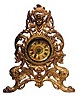 Gilt novelty clock. Very ornamental, gold plated, metal frame, 11 inches high.