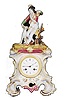 Porcelain figural clock and stand.