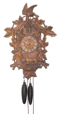 Large carved cuckoo clock with fox, bird, and grapes. 24 inches high. — Antique Clocks Price Guide