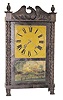 Early shelf clock with carved half columns and splat, pineapple finials, claw feet. The old label reads, "Manufactured for George Mitchell, by Atkins & Downs, Bristol, Conn". It was made around 1831-1832.