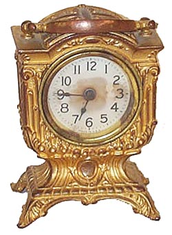 Jennings Brothers novelty. Metal case is 5-1/2 inches high with handle up, signed on the base "JB". — Antique Clocks Price Guide