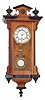 German miniature RA, 15 inch walnut case designed like the big ones, finials top and bottom, black trim around the edges and finials, 3 glasses, 2 piece porcelain dial, porcelain beat scale, porcelain RA pendulum.